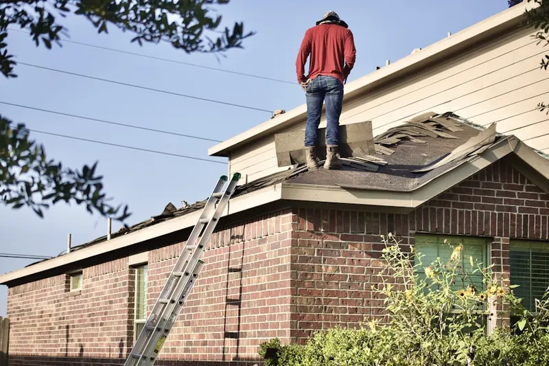 Professional roofer working on a residential roof in Strawberry Farms